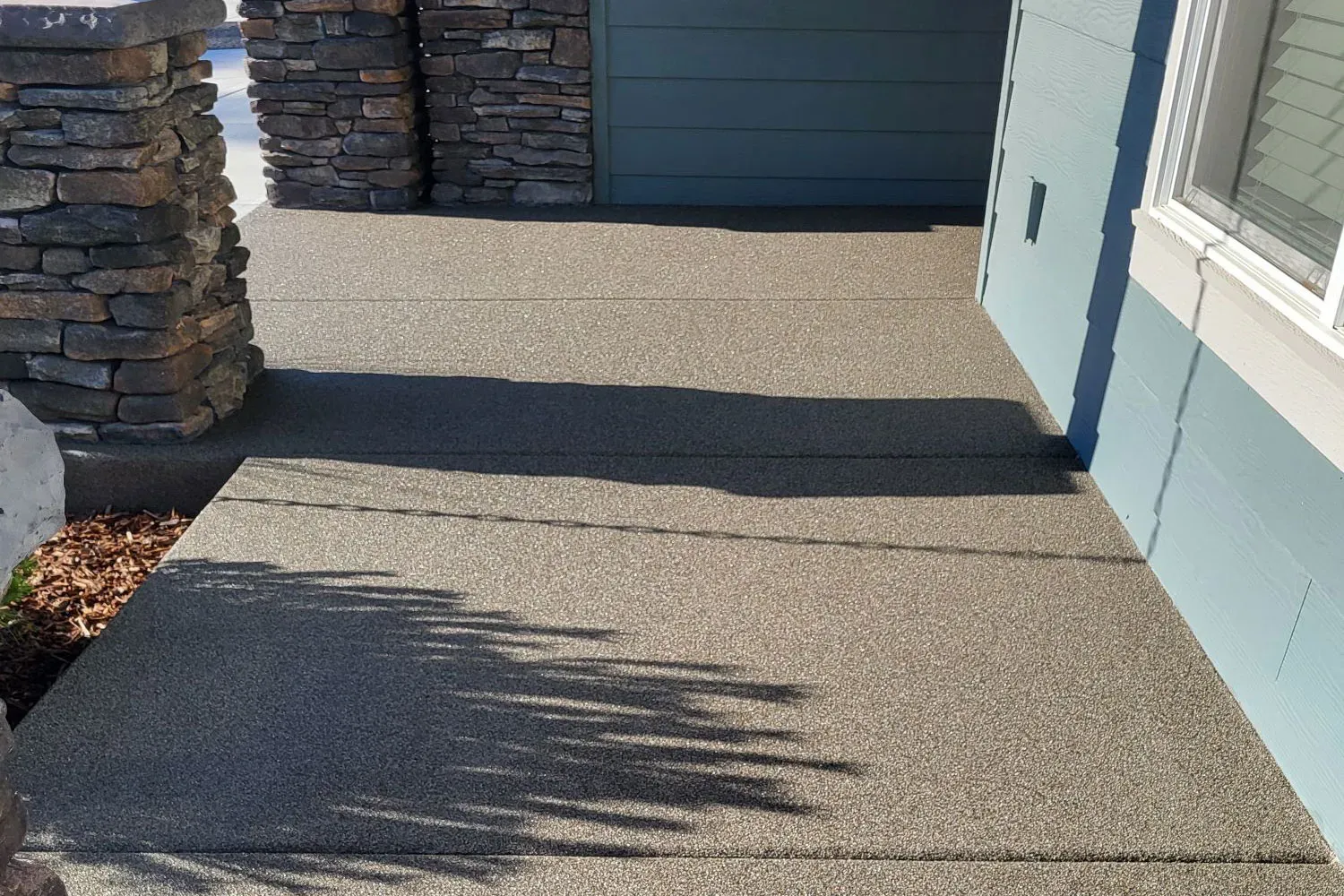 Close-up of a Boardwalk crushed-basalt sand-overlay surface.