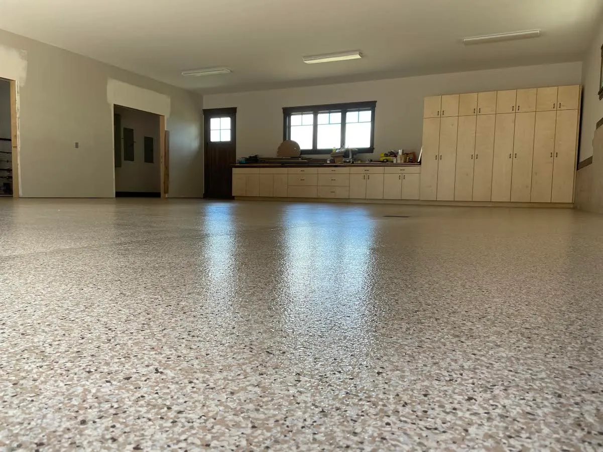 Warehouse interior with a light neutral flake floor coating running wall to wall.