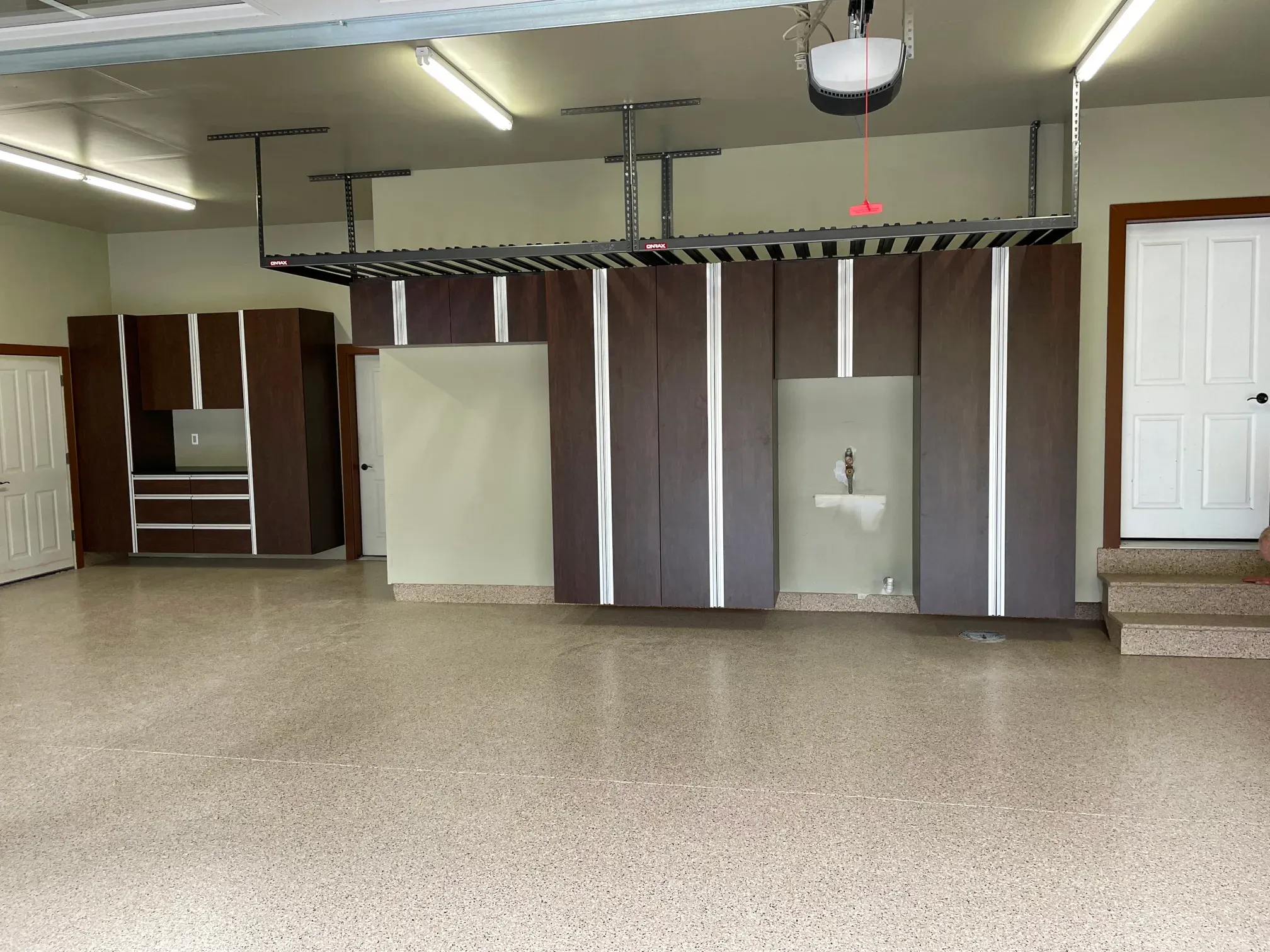 Dark Walnut garage cabinets above a Basalt flake-coated garage floor.