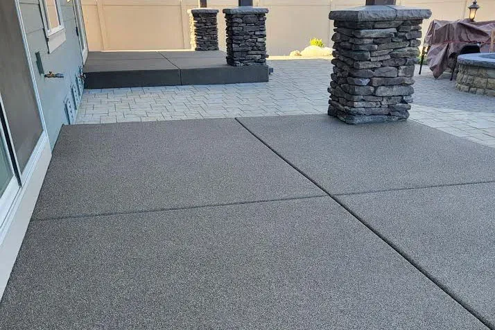 Covered patio with a Boardwalk basalt sand-overlay surface.