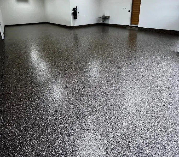 Room with a dark Rimrock flake-coated concrete floor and white walls.